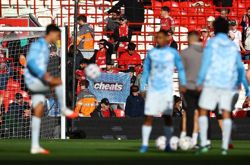 Soccer-Boos, 'cheat' taunts greet Manchester City at Anfield
