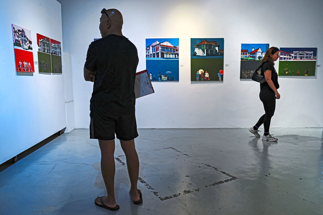 Guests tour the exhibition and view artworks on display at the exhibition.