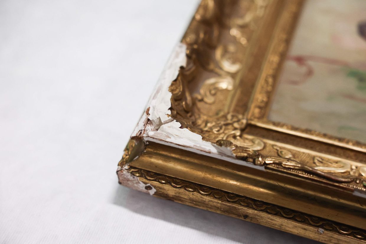 This media handout shows slight damage on the frame of the 'Young Woman At The Well' painting by French impressionist painter Renoir. Photo: AFP 