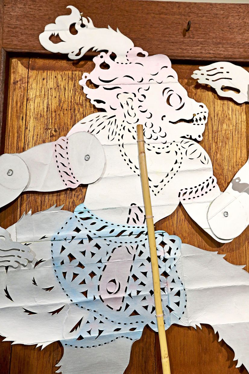 A close-up view of a shadow puppet from Chin’s 'Holding Form' series, made from recycled Tetra Pak cartons.