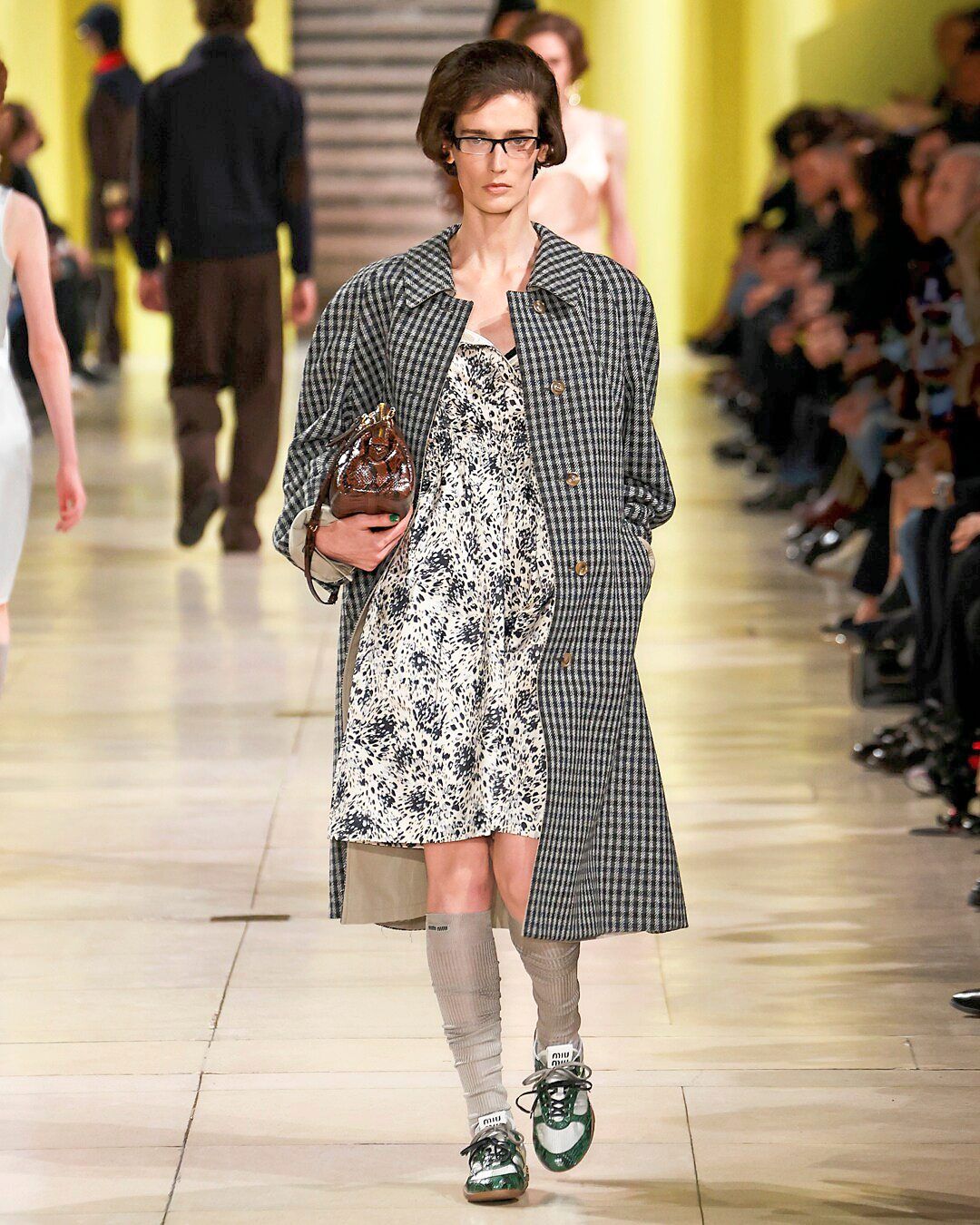Pictured here on one Autumn/Winter 2025 runway, over-the-calf socks are another key element of the nerdy-but-fashionable look. Photo: Miu Miu