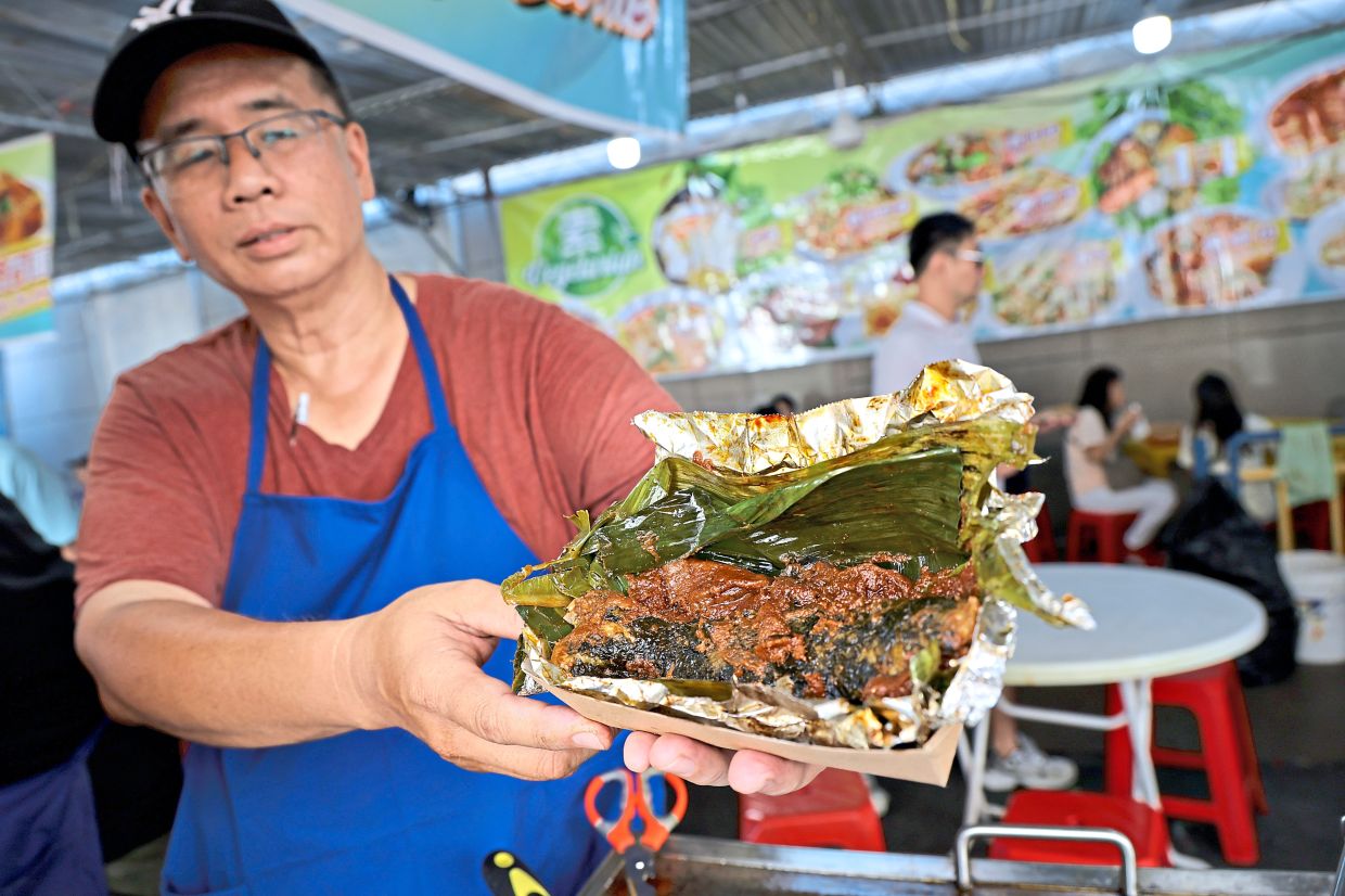 Leng showing the vegetarian grilled fish he sells in Madras Lane as part of meat-free highlights that can be found during the festival.