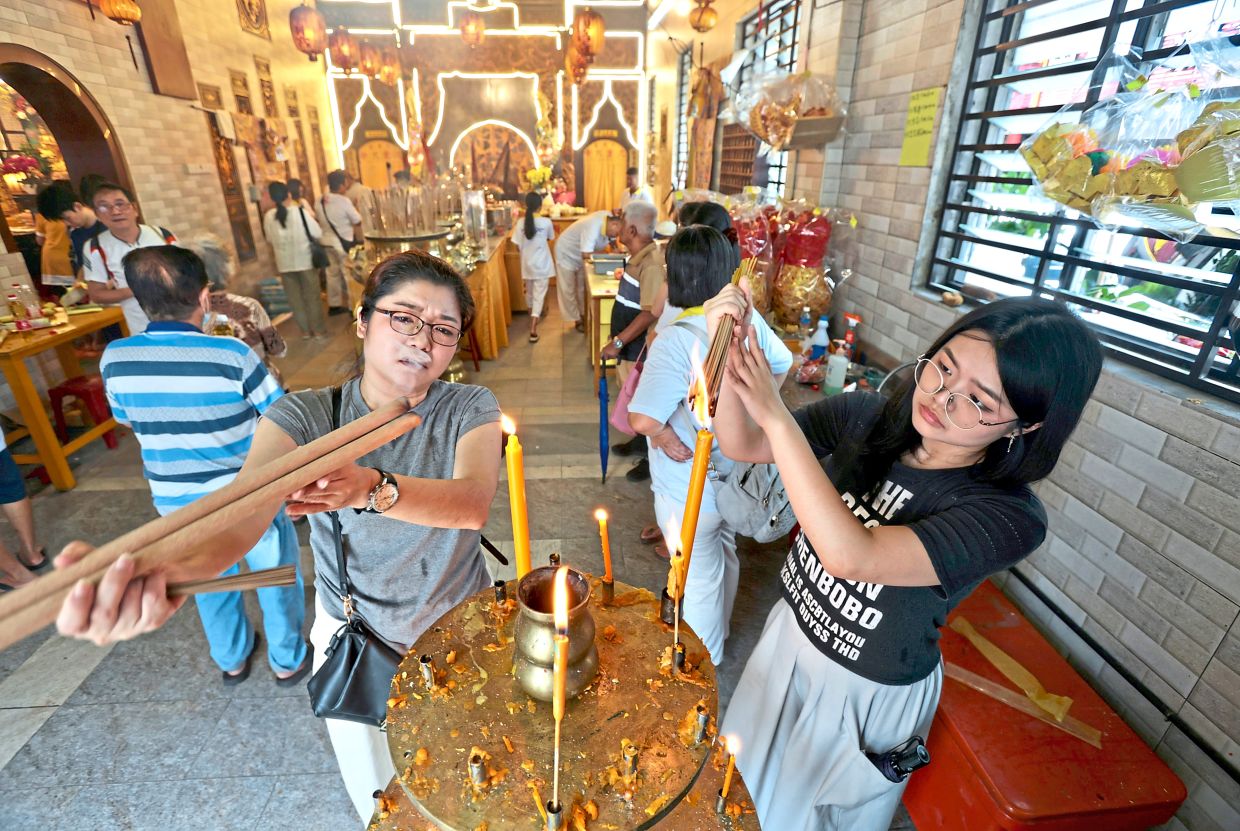 Devotees praying at Kuan Im See temple in Jalan Burma during the festival in George Town.