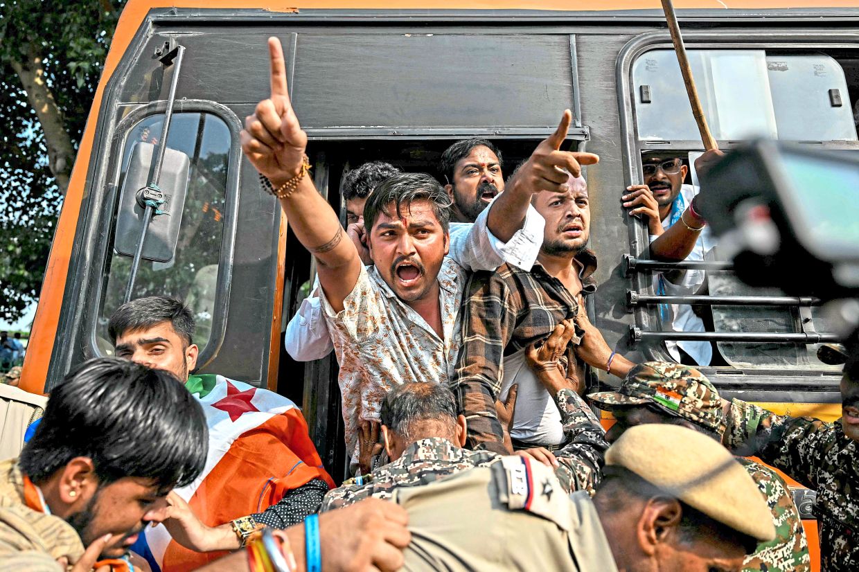 Rally crackdown: Security personnel detaining student activists during a protest in New Delhi. — AFP
