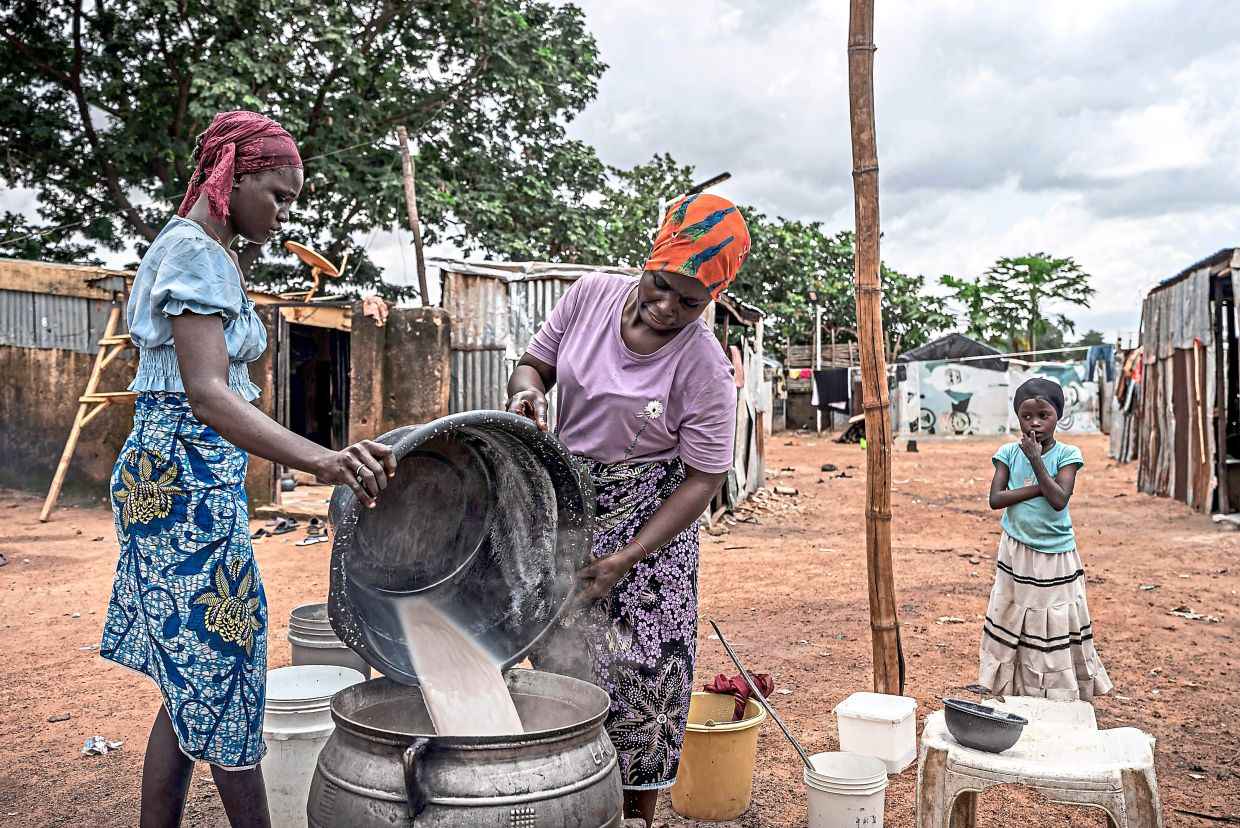 Women cooking and resting at an internally displaced persons camp in Durumi, Abuja. — AFP
