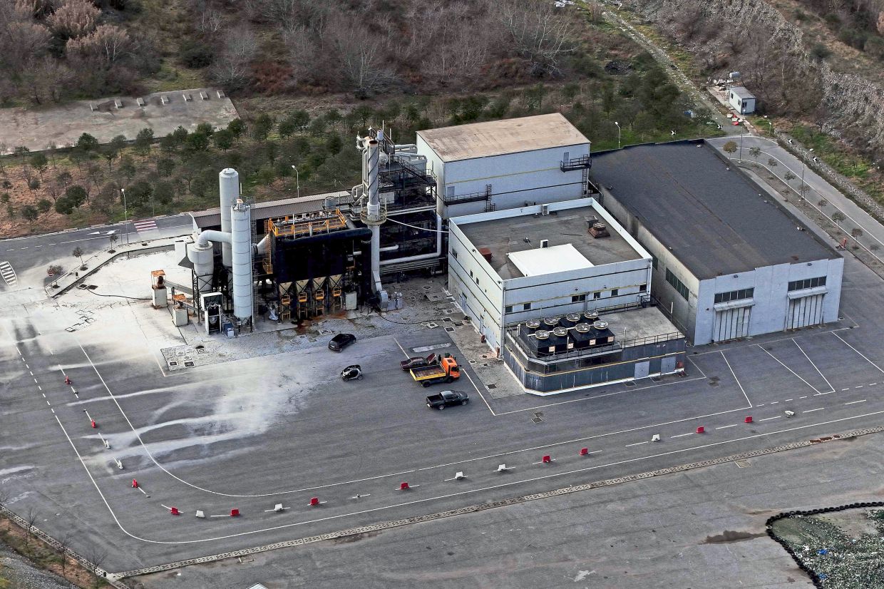An incinerator some 40km east of Tirana; and (below) containers of toxic industrial waste stored at a controlled site near the port city of Durres. — AFP