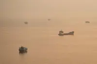 Two Singapore-registered vessels hit in the Strait of Hormuz, one sinks