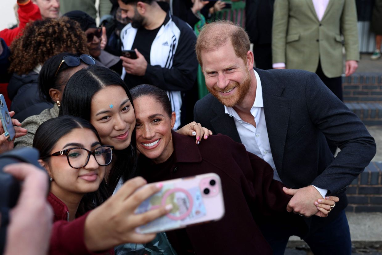 Britain's Prince Harry, Duke of Sussex and his wife Meghan, Duchess of Sussex, greet wellwhishers. Photo: AFP
