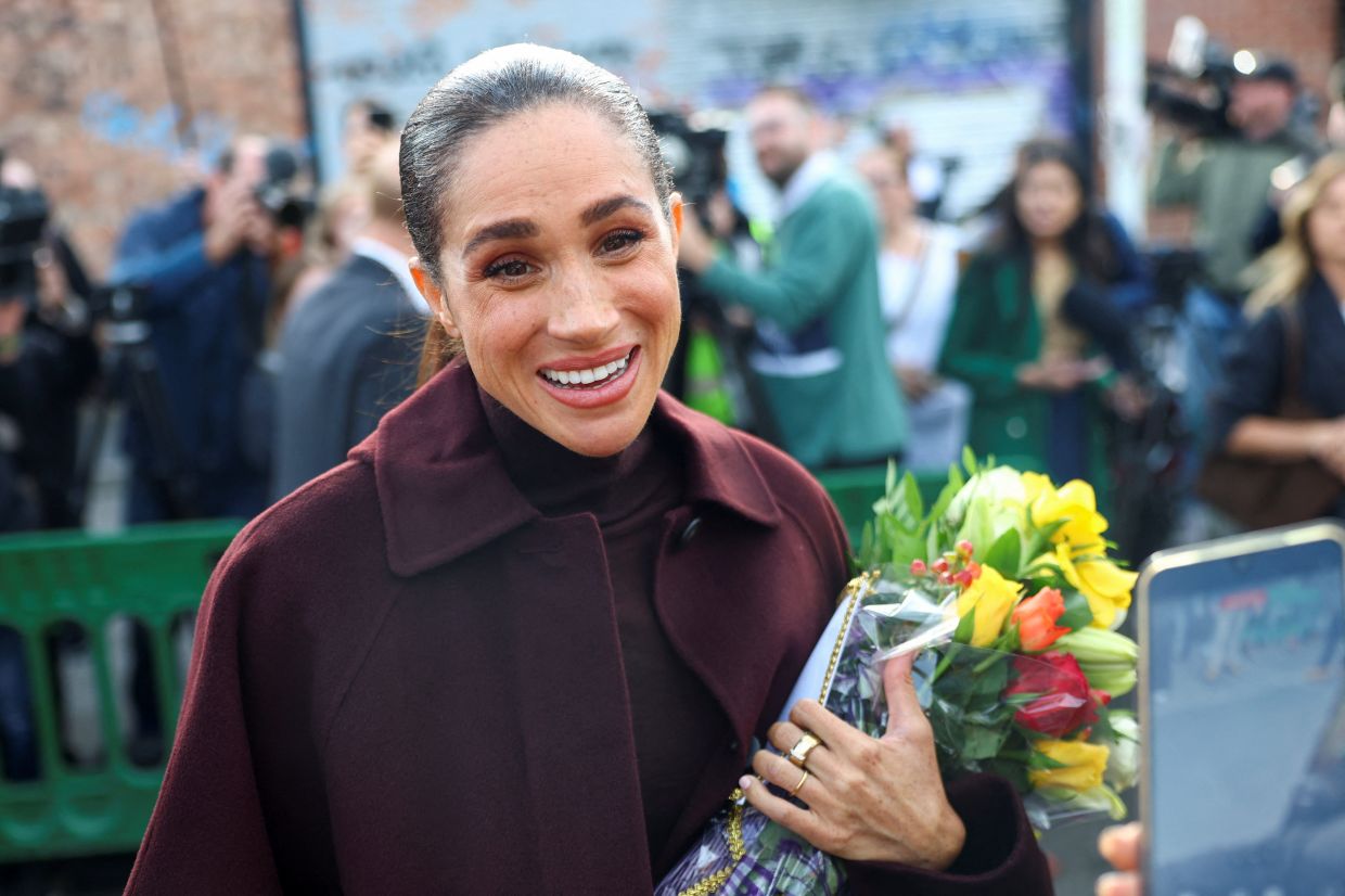Britain's Meghan, Duchess of Sussex, meets with people upon her arrival for a visit to The Community Recording Studio, a youth and community charity supporting young people through creative activities, mentoring and youth development. Photo: Reuters