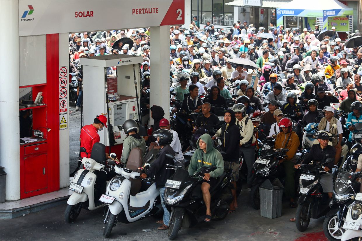 Motorcyclists queueing to refuel at a state-owned Pertamina petrol station amid a fuel supply shortage in Badung, Bali, Indonesia on Oct 15, 2026. - Reuters