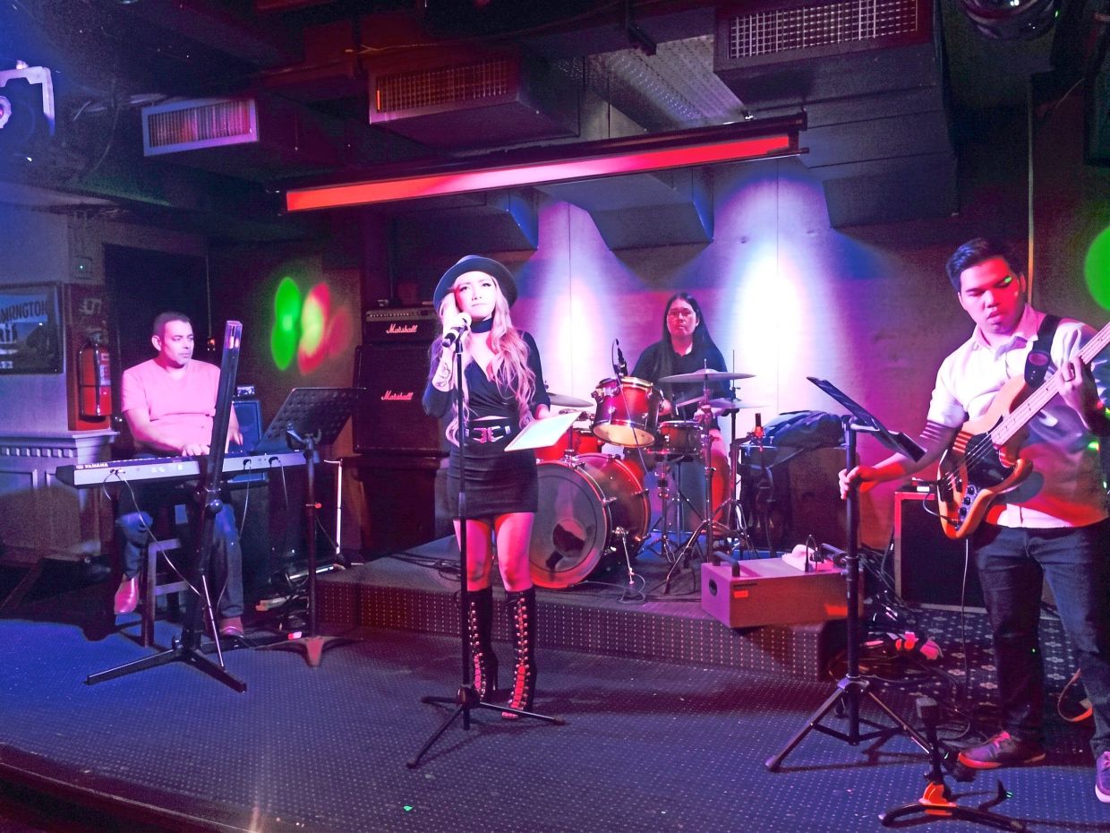 A local band entertaining the crowd and a customer grooving on a retro night (below).