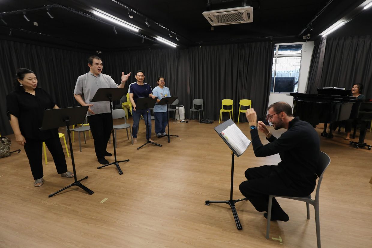 Mazzocchetti (right) leads a recent 'Turandot' rehearsal, an ambitious opera show that opens at KLPac on Oct 17. Photo: The Star/Yap Chee Hong 
