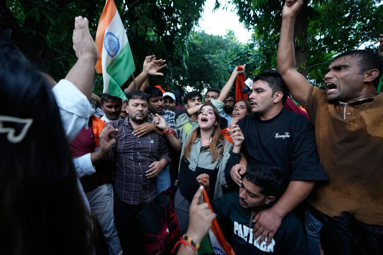 Activists shout slogans during a - Tiranga March - organized by the youth - Cockroach - movement, demanding the resignation of India's chief election commissioner, in central New Delhi, India, Friday, Oct. 16, 2026.(AP Photo/Channi Anand)