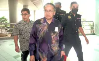 Ex-director denies power abuse charges