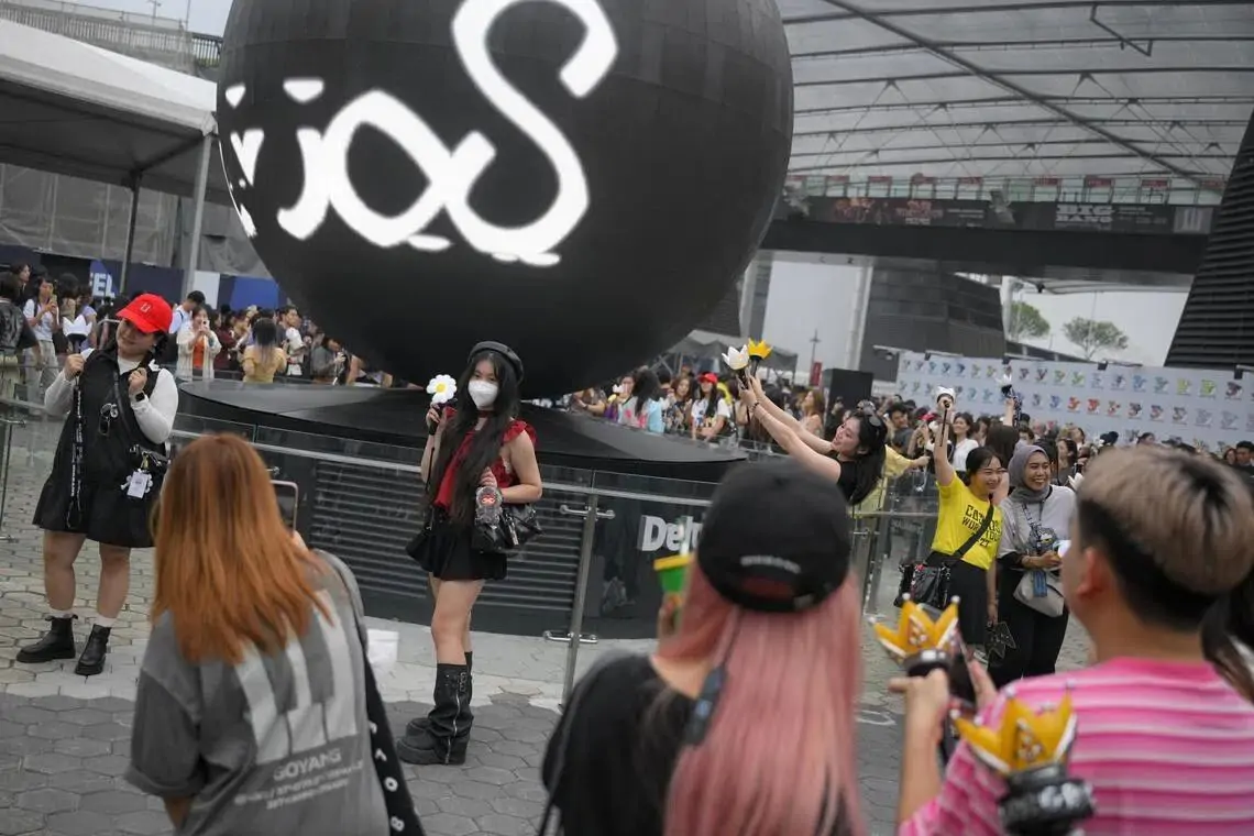 Fans brave the heavy rain and haze to catch the K-pop superstars