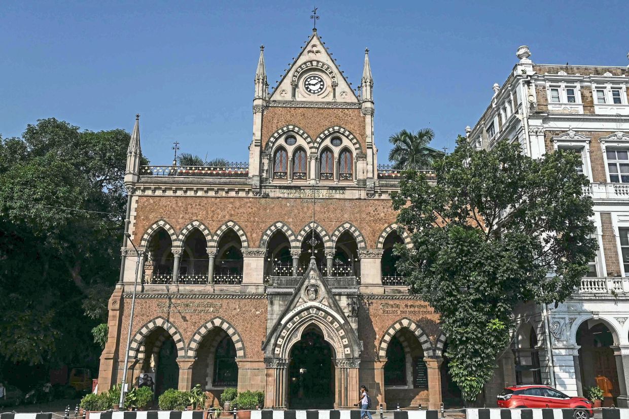 A woman walks past the David Sassoon Library building in Mumbai. Photo: AFP