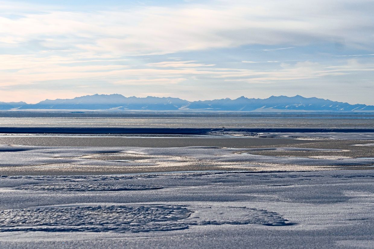 The Kaktovik Lagoon and the Brooks Range mountains of the Arctic National Wildlife Refuge are visible in the distance in Kaktovik, Alaska.