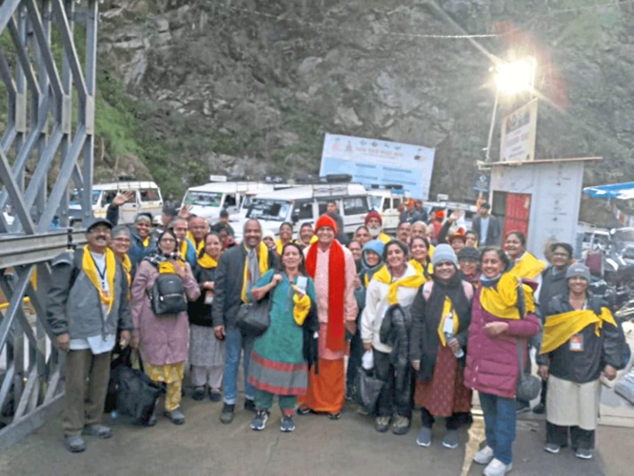 Swamiji Udit Chaitanya in the centre wearing an orange hood with the writer on his left (in white with a yellow scarf).