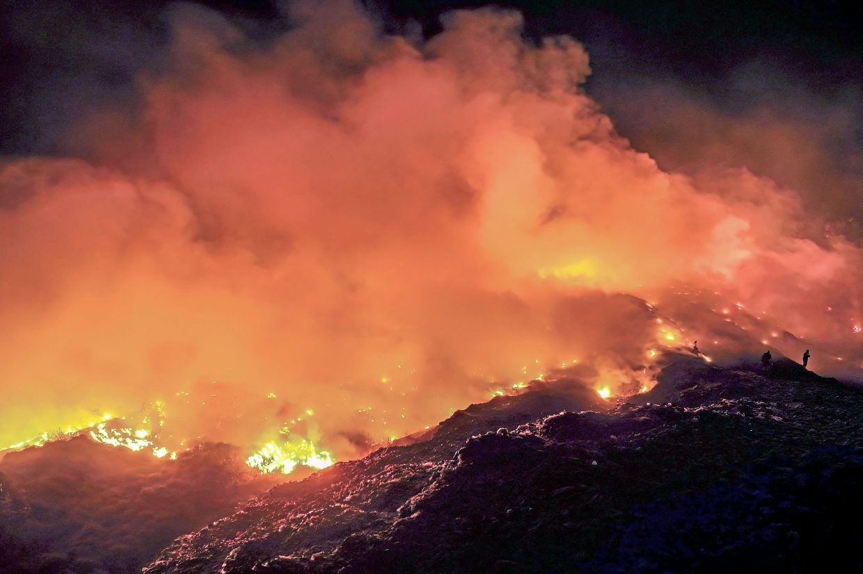 A fire burning at a landfill site in Rasau Jaya, Kubu Raya, West Kalimantan, Indonesia in August.