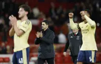 Soccer-Slow-starting Arsenal make patience pay against Forest