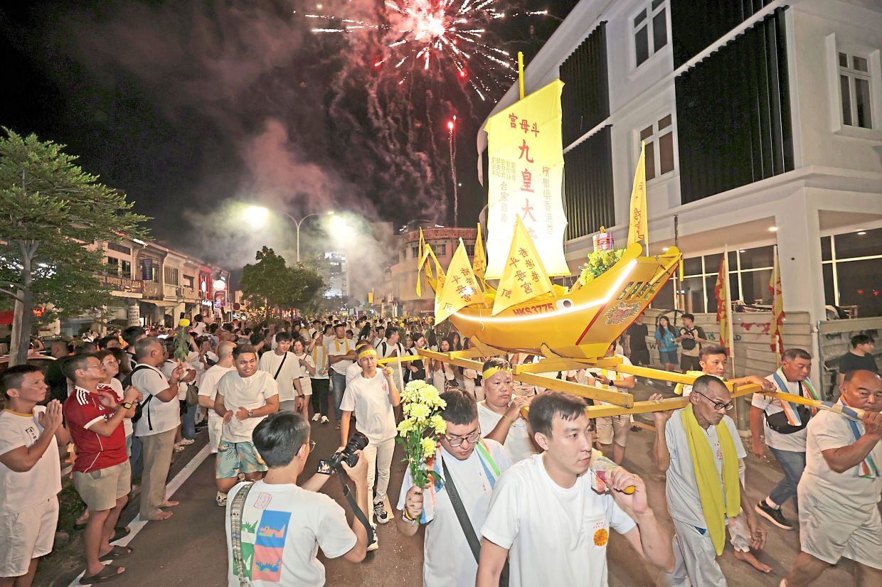 Devotees taking part in a grand procession, replete with fireworks, to mark the last day of the Nine Emperor Gods Festival in George Town. — Filepic