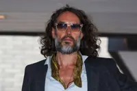 Woman says Russell Brand dragged her into bar toilet and raped her, court hears