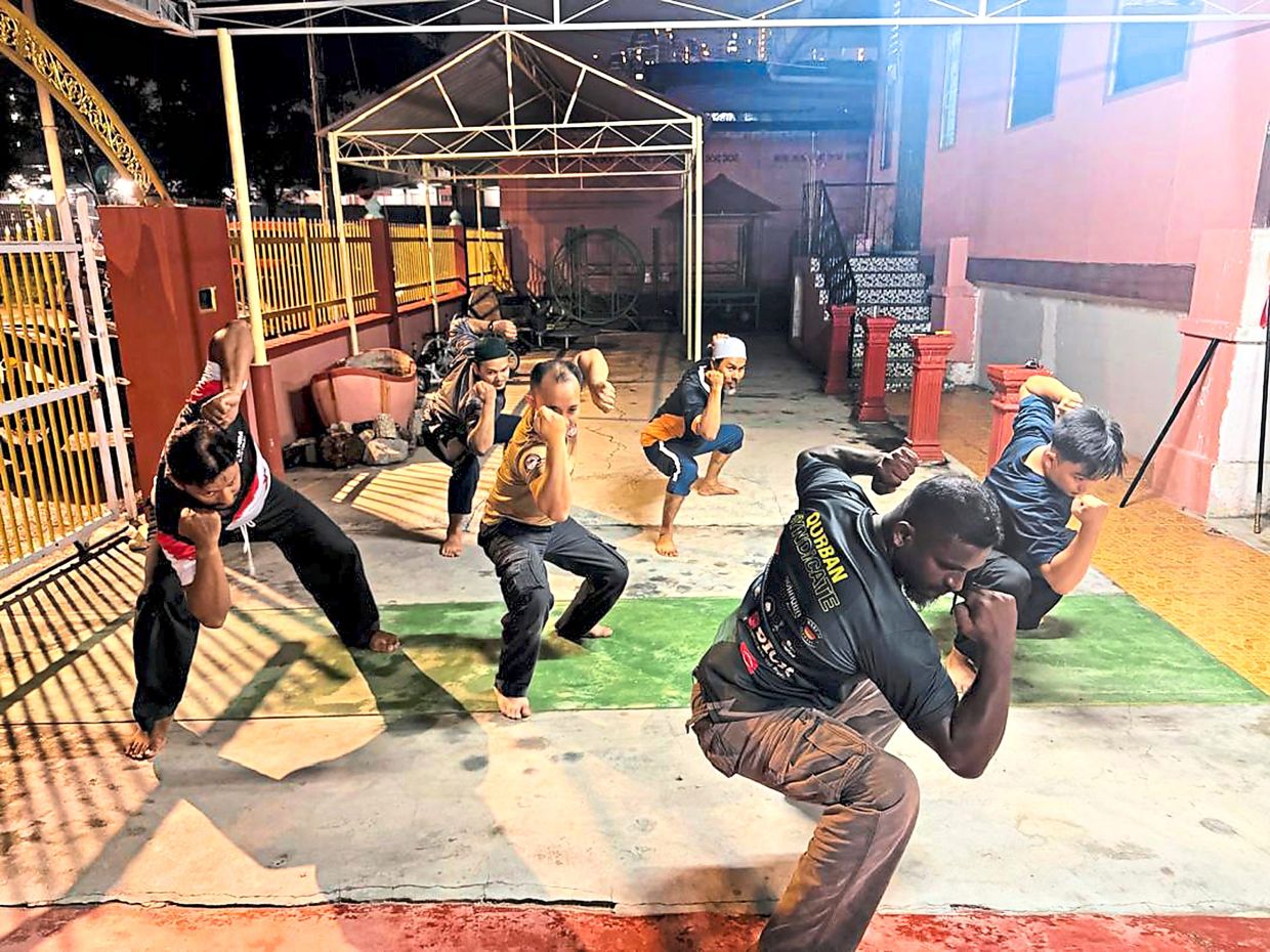 Silat Pelaga Siku 12 practitioners in action. This martial art was first practised around 1932 before gaining wider prominence around 1947.