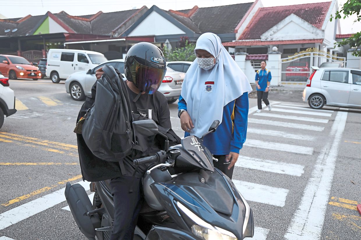 All protected: Students returning to school wearing face masks in Johor Baru amid the haze situation. — Bernama