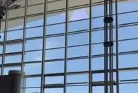 Woman injured after part of glass wall at KKIA falls off