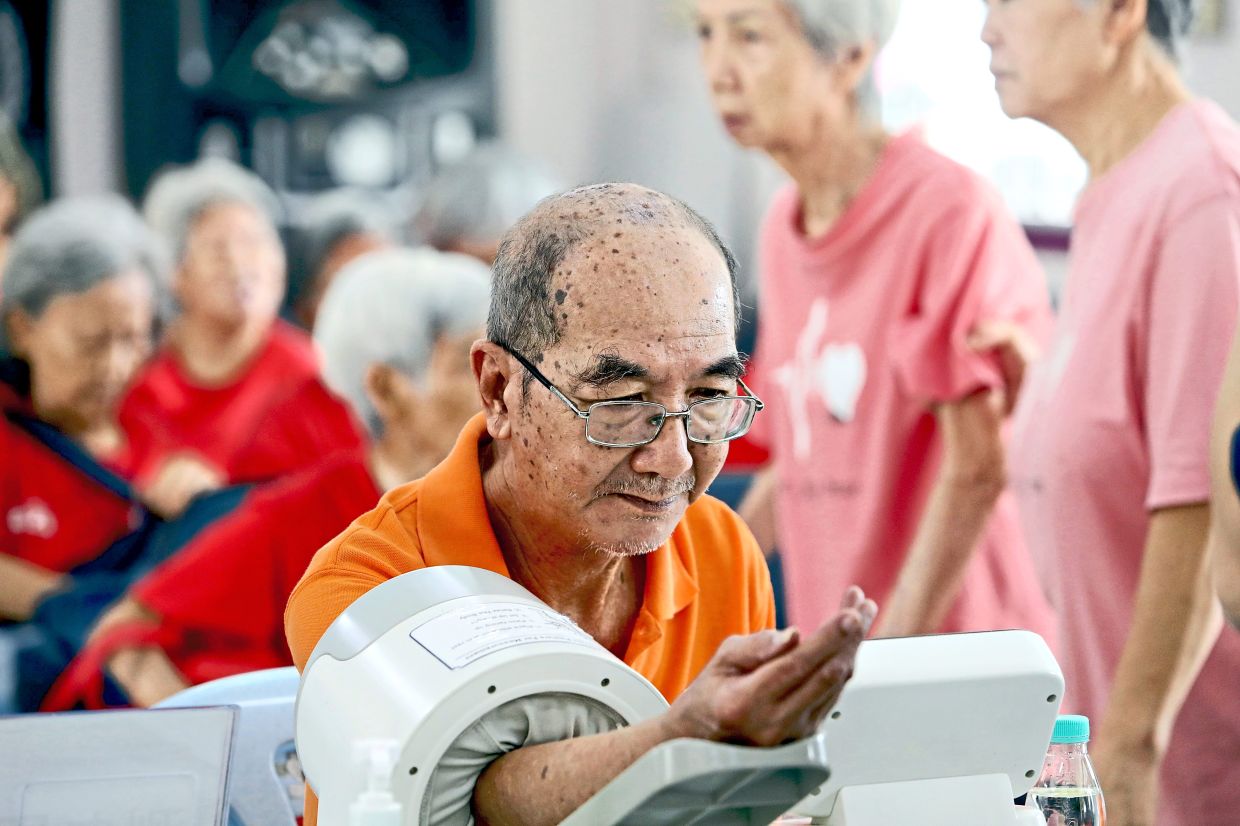 A senior citizen getting his blood pressure checked during the luncheon.