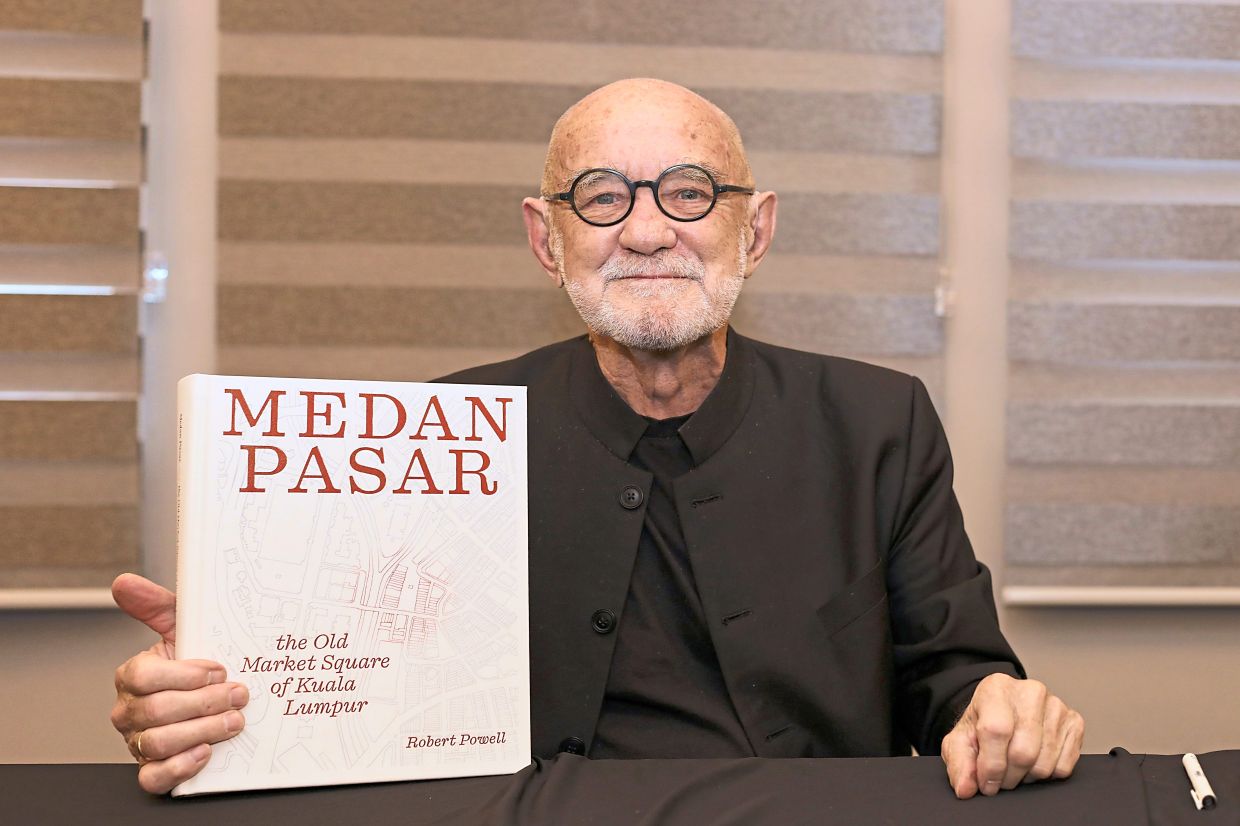 Prof Powell with his book 'Medan Pasar: The Old Market Square of Kuala Lumpur'.