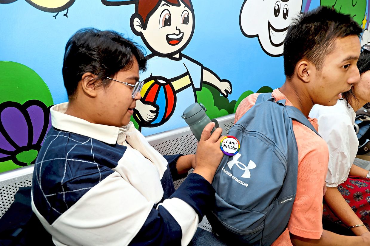 Caring for Harith Rafael (right) can be challenging but Hannah Mikhaela remains patient and understanding of her brother's needs.