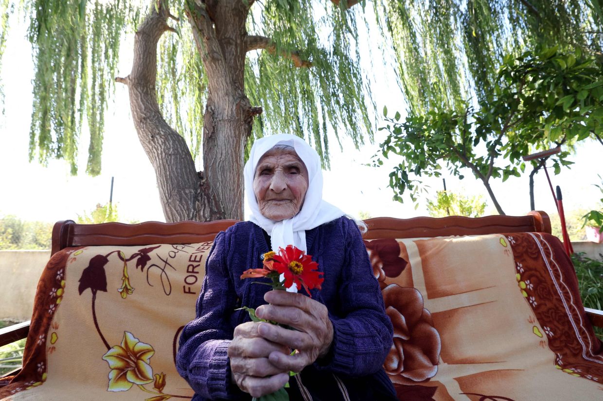 The 117-year-old Qamile Marra poses during an interview with AFP.