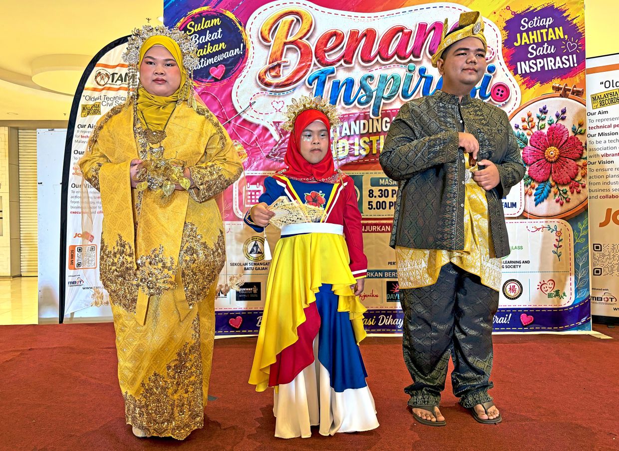 (From left) Nur Sofea, Nur Aina and Meor Saffwan taking part in the catwalk performance.