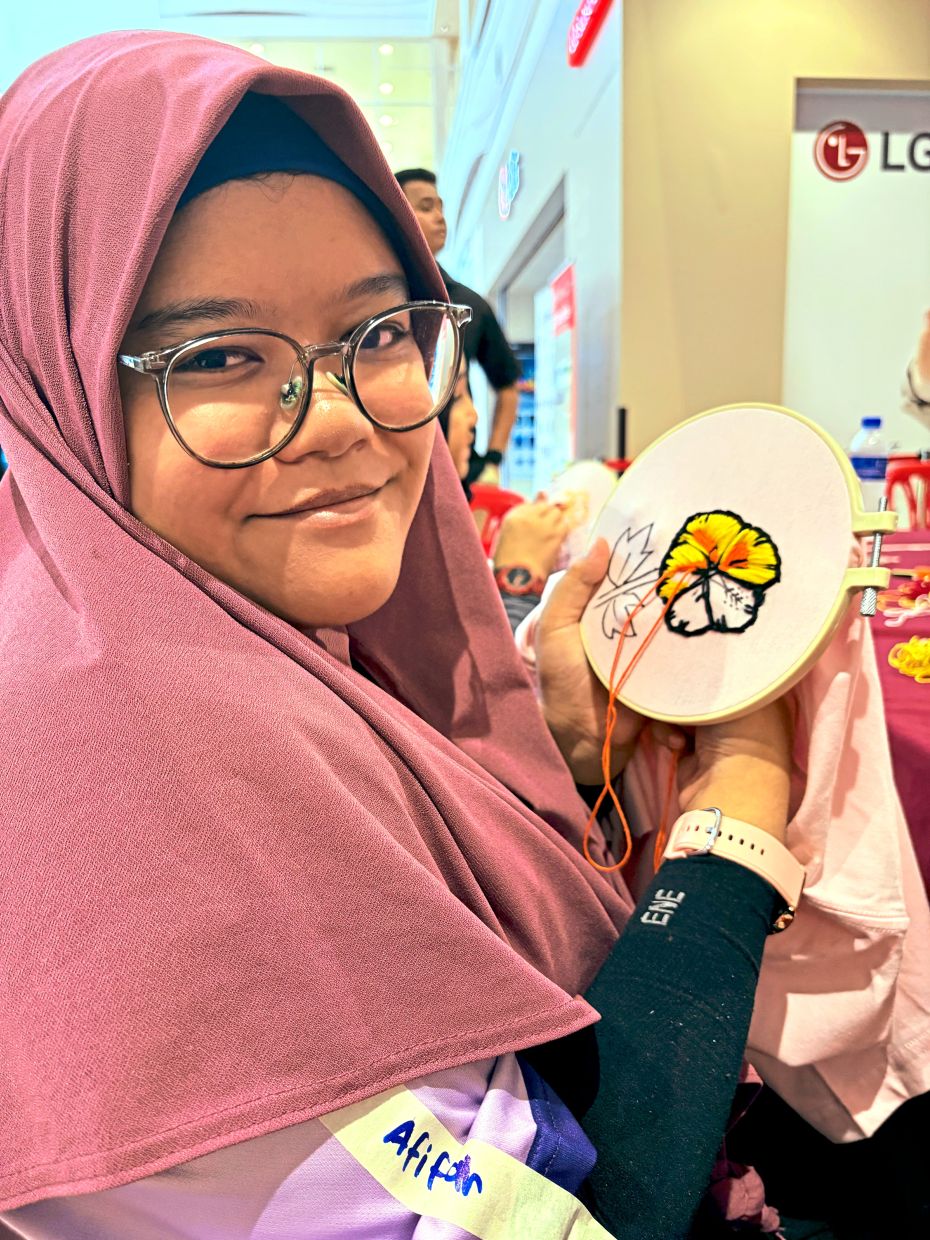 Nurul Afifah proudly showing her half-completed work.