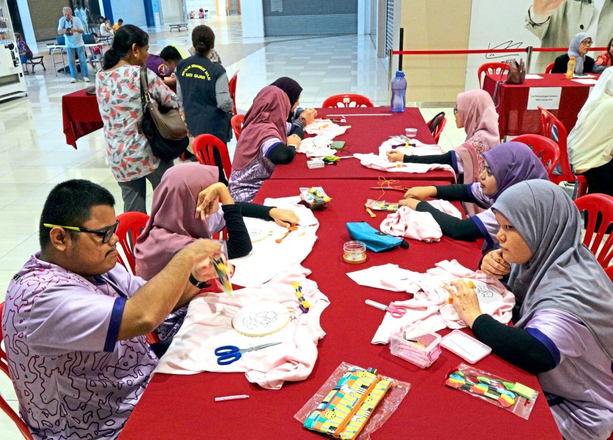 Participants painstakingly working on their creations at the ‘Benang Inspirasi’ embroidery competition in Ipoh.