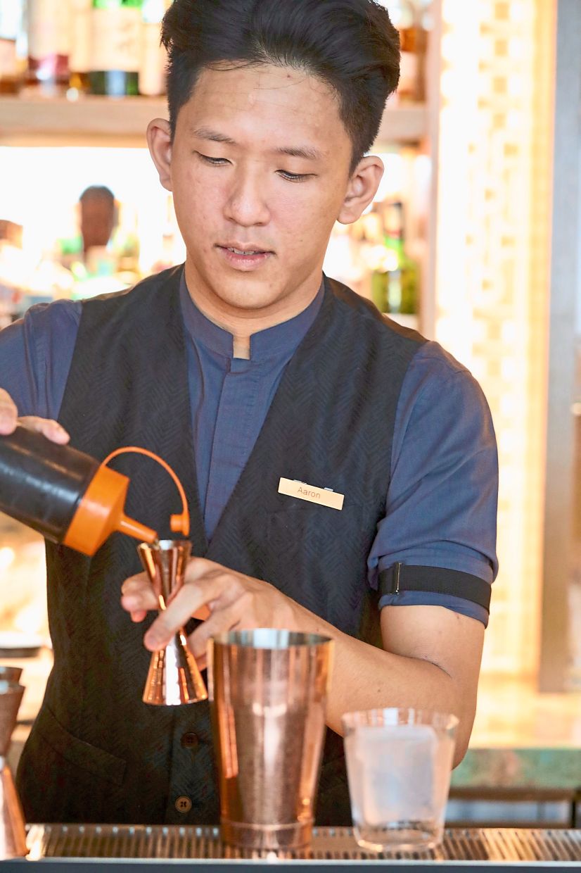 Lee adding the finishing touches to a cocktail at Cacao Mixology and Chocolate.