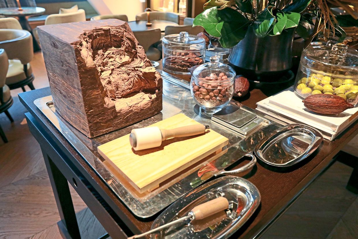 The Chocolate Table offering chocolate dragees, pralines, brittles, truffles and chippings from a chocolate block.