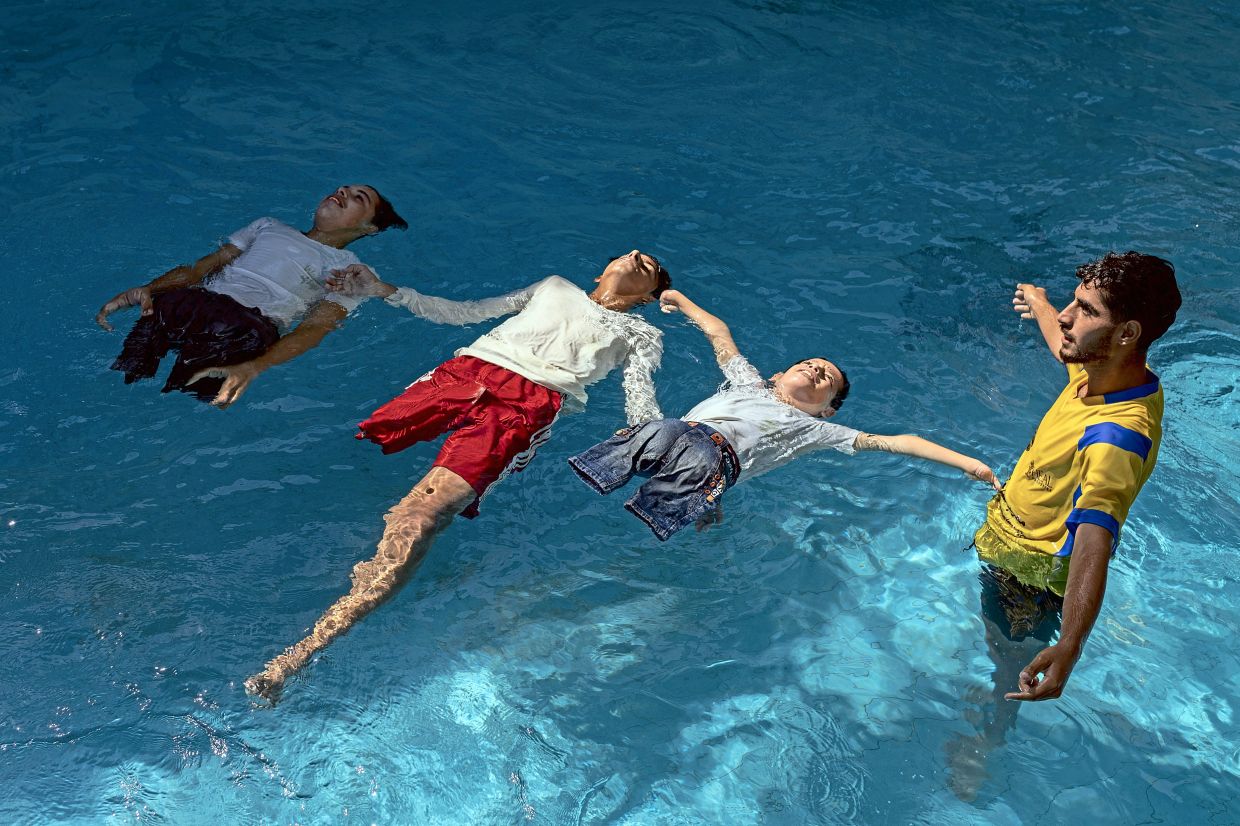 Children, some of whom lost limbs in the war, learning to float during a swimming class in Khan Yunis, southern Gaza. — Saher Alghorra/The New York Times