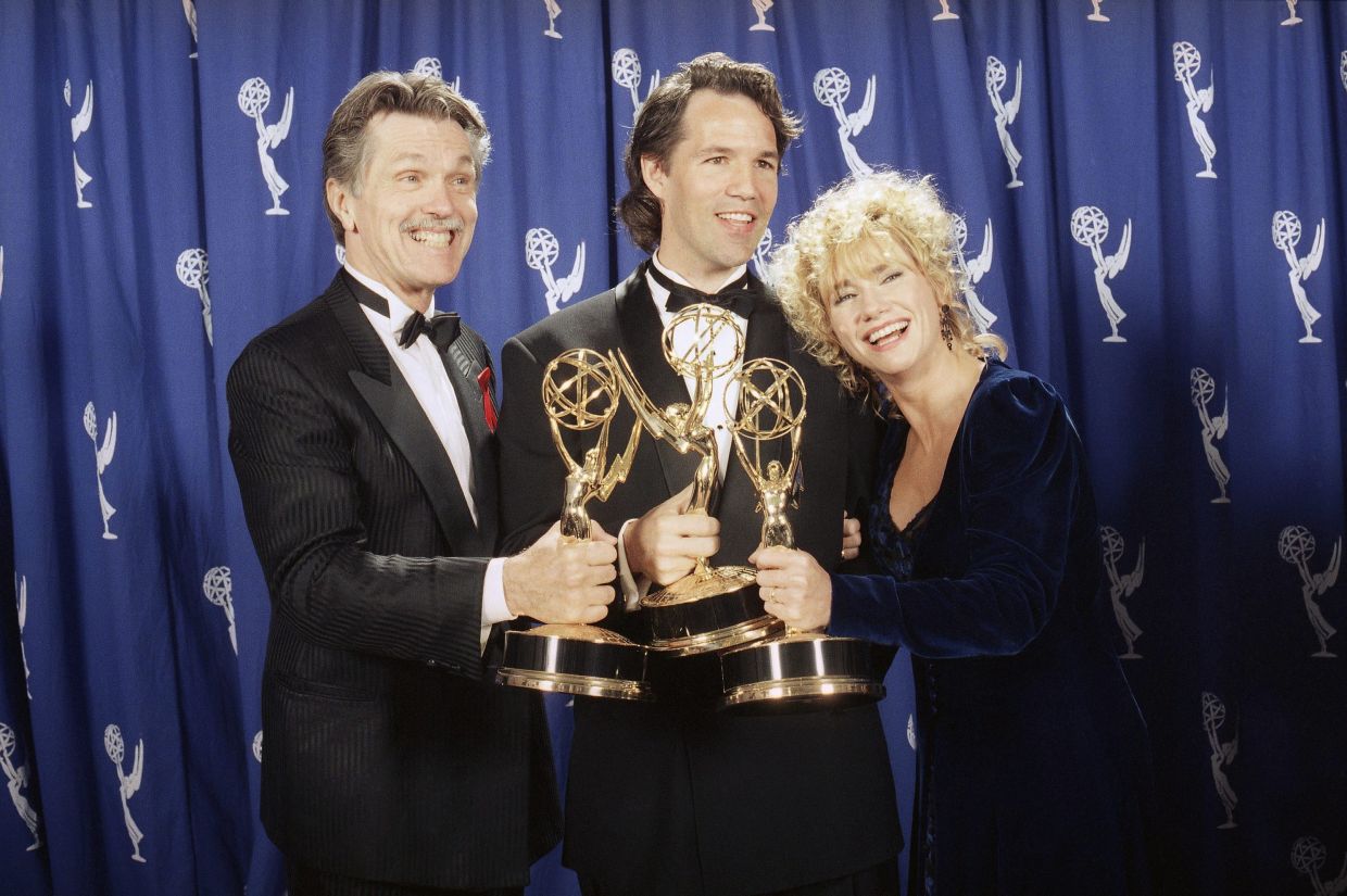 David E. Kelley (centre), creator of 'Picket Fences', poses with actors Tom Skerritt, left, and Kathy Baker after show won best drama series during the 45th annual Emmy Awards on Sept 19, 1993. Photo: AP