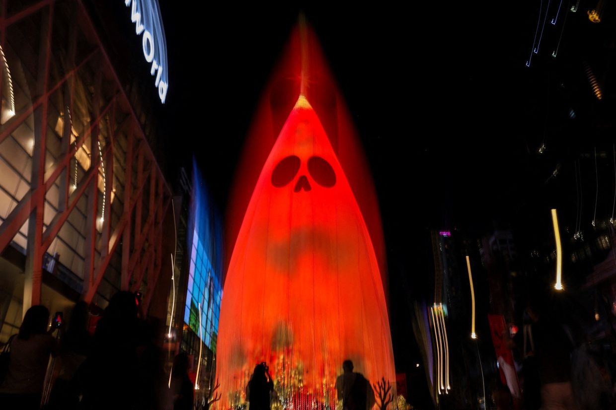 People take pictures of a giant - Spooky Boo - installation during a Halloween-themed event at Central World shopping mall in Bangkok, Thailand, on Friday, October 23, 2026. -- Photo: REUTERS/Chalinee Thirasupa