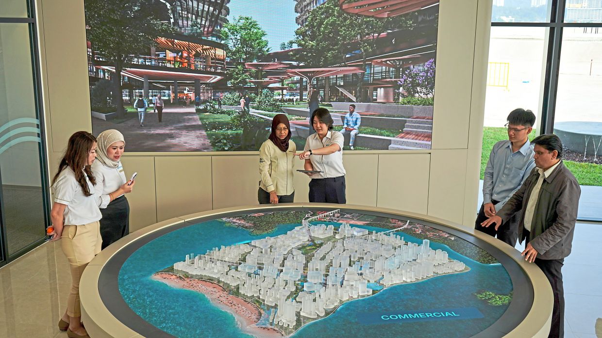 Chow (middle) at the soft launch of the Silicon Island Experience Centre with (from left) Zairi, Rashidi, Goh, Farizan, Zairil, Szeto, Wong and Faizal. (Right) The scale model displays proposed road network, public transport corridors, green spaces and other features of the island. — Photos: Handout