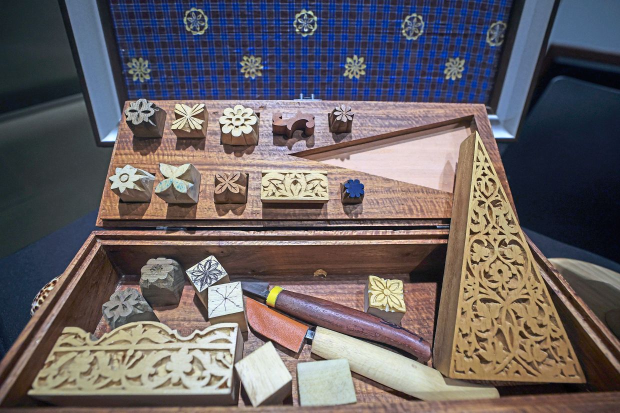 Above: Carved wooden printing blocks used to make ‘telepuk’ art motif.