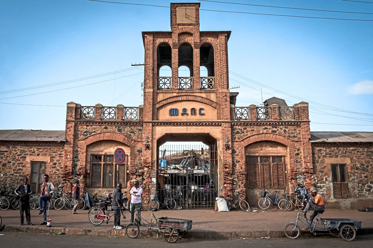 People standing with bicycles outside the Medeber Market, an open-air recycling and craft market in downtown Asmara, Eritrea, on June 22. Eritrea has long been isolated by the West, which views the East African country as among the most repressive in the world, while the government in Asmara has itself pursued a policy of political and economic seclusion. — Reuters