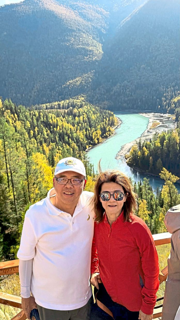 The writer's friends, Boon (left) and Karen, posing with the Kanas Moon Bay in the background.