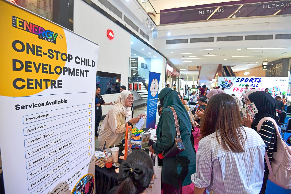 Members of public getting more information about child development from one of the booths set up during the event.