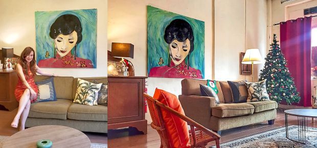 Tan (left) posing in front of her self-painted qipao artwork at 27 Ah Peng, her homestay in Bentong.
