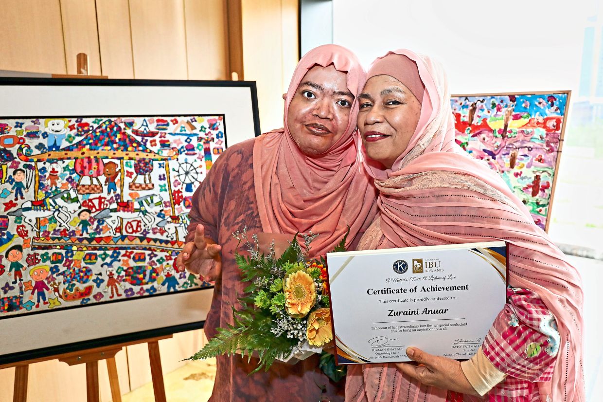 Zuraini (right) with her daughter, self-taught autistic and neurodivergent acrylic painter Izzati Shahrin.