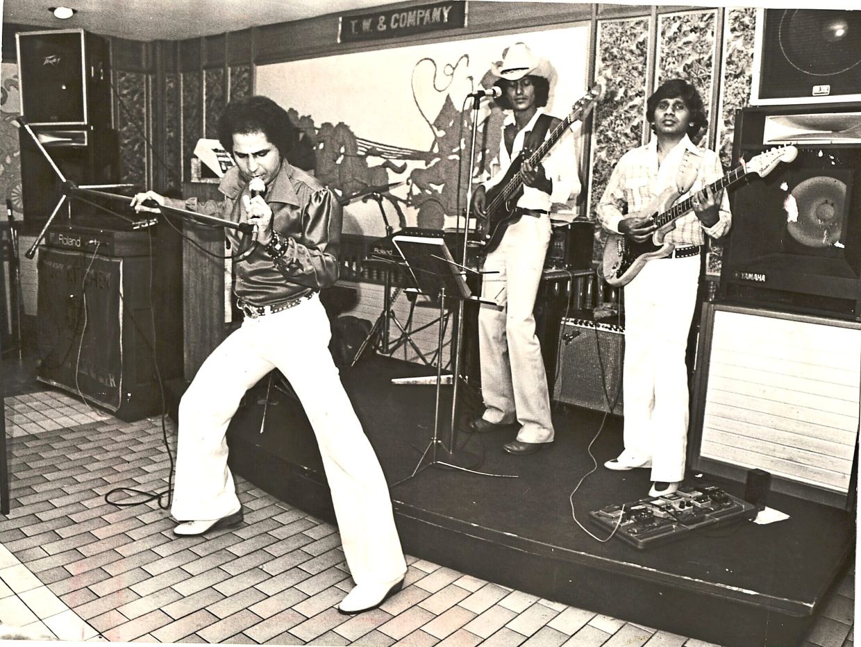 From left: Warren performing with fellow musicians Terry Rajan and Mike Maniam.