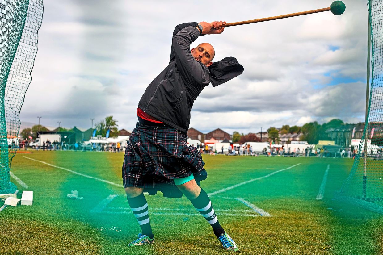 A participant in the hammer throw event at the Highland Games.